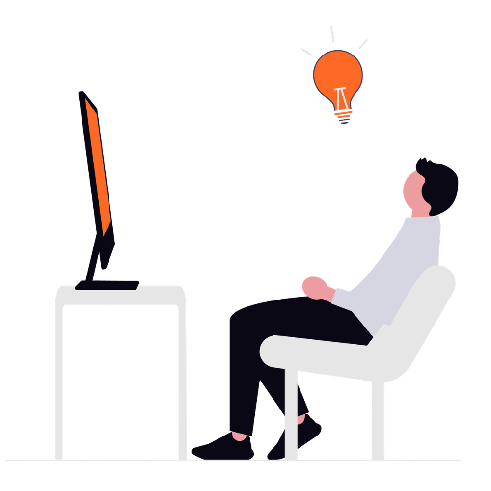Image of a man with an idea sitting infront of a computer